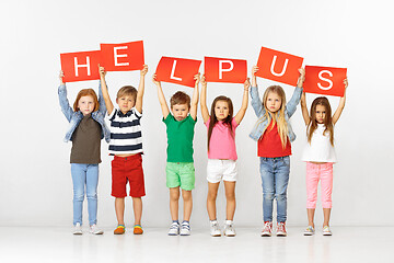 Image showing Help us. Group of children with red banners isolated in white