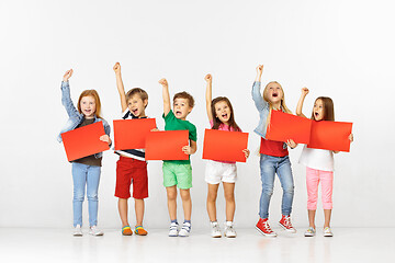 Image showing Group of children with red banners isolated in white