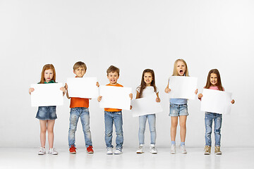 Image showing Group of children with a white banners isolated in white