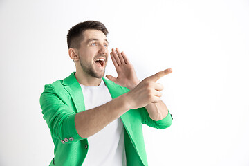 Image showing The happy businessman standing and smiling against gray background.