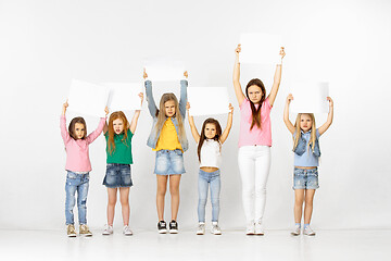 Image showing Group of children with a white banners isolated in white