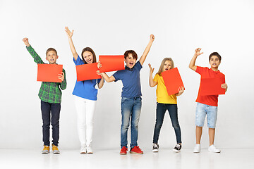 Image showing Group of children with red banners isolated in white