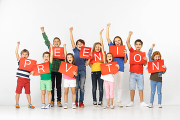 Image showing Group of children with a red banners isolated in white