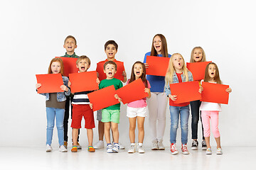 Image showing Group of children with a red banners isolated in white