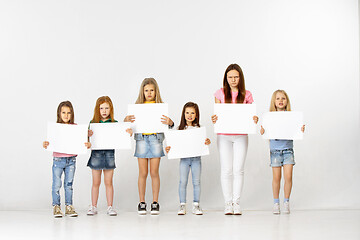 Image showing Group of children with a white banners isolated in white