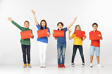 Image showing Group of children with red banners isolated in white