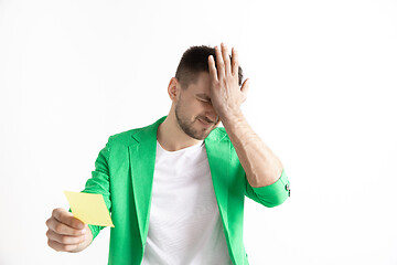 Image showing Young boy with a surprised unhappy failure expression bet slip on studio background.