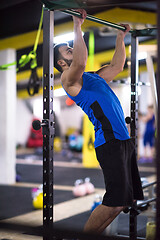 Image showing man doing pull ups on the horizontal bar