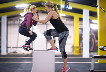 Image showing athletes working out  jumping on fit box