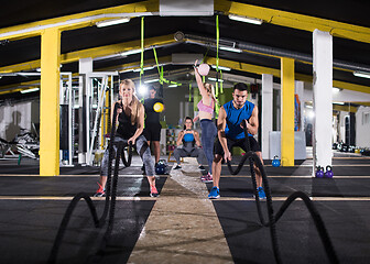 Image showing sports couple doing battle ropes cross fitness exercise