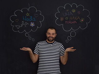 Image showing young future father thinking in front of black chalkboard