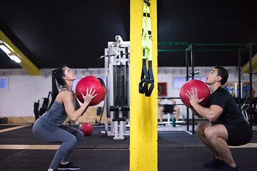 Image showing young athletes couple working out with medical ball