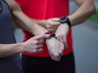 Image showing sporty couple using smart watches