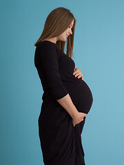 Image showing Portrait of pregnant woman over blue background