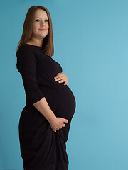 Image showing Portrait of pregnant woman over blue background