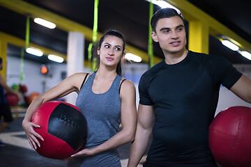 Image showing young athletes couple working out with medical ball