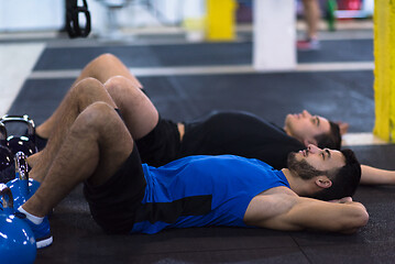 Image showing young athletes lying on the floor and relaxing