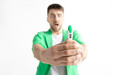 Image showing Upset man looking in pregnancy test. Frustrated model