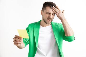 Image showing Young boy with a surprised unhappy failure expression bet slip on studio background.