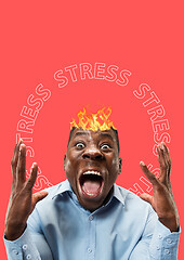 Image showing African-american man with fliming head stressed out