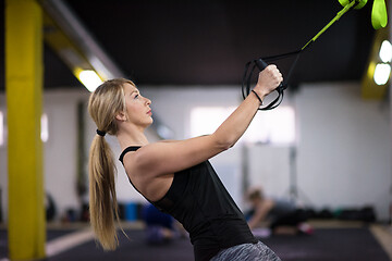 Image showing woman working out pull ups with gymnastic rings