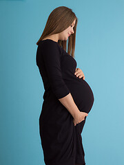 Image showing Portrait of pregnant woman over blue background