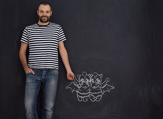 Image showing future dad drawing his imaginations on chalk board