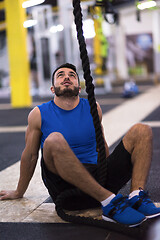 Image showing man relaxing before rope climbing