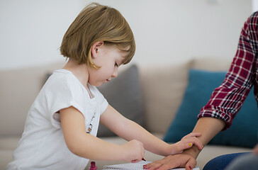 Image showing daughter painting nails to her pregnant mom