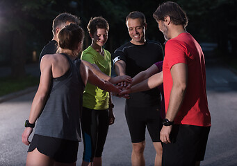 Image showing runners giving high five to each other