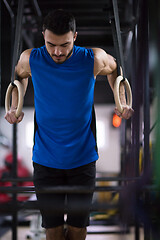 Image showing man working out pull ups with gymnastic rings