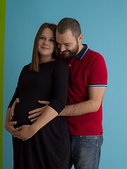 Image showing pregnant couple  isolated over blue background