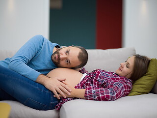 Image showing future dad listening the belly of his pregnant wife