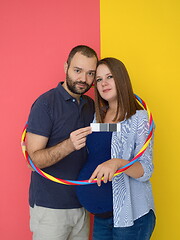 Image showing pregnant couple  isolated over colorful background