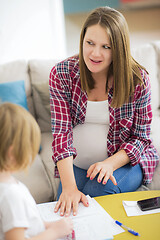 Image showing daughter painting nails to her pregnant mom