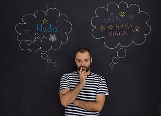 Image showing young future father thinking in front of black chalkboard