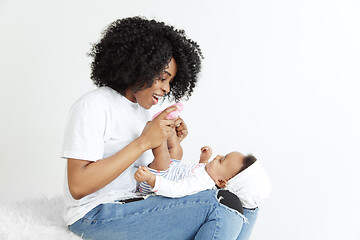 Image showing Portrait of beautiful african woman holding on hands her little baby