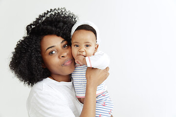 Image showing Portrait of beautiful african woman holding on hands her little baby