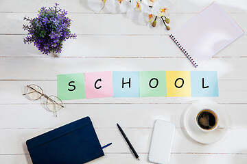 Image showing Stationery and word SCHOOL made of letters on wooden background