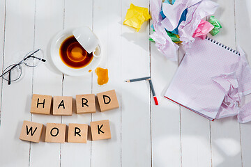 Image showing HARD WORK. Message in wooden cubes on a desk background.