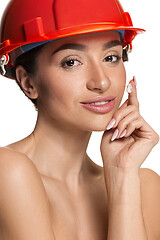 Image showing Portrait of confident female worker in orange helmet