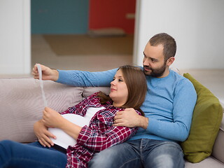 Image showing pregnant couple looking baby\'s ultrasound