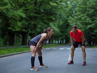 Image showing runners team warming up and stretching before morning training