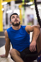 Image showing man relaxing before rope climbing