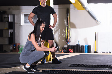 Image showing sports couple doing battle ropes cross fitness exercise