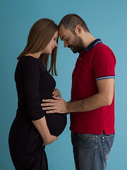 Image showing pregnant couple  isolated over blue background