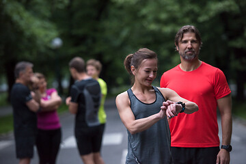 Image showing sporty couple using smart watches