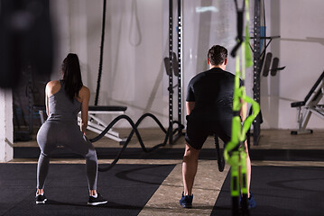 Image showing sports couple doing battle ropes cross fitness exercise