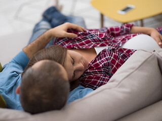 Image showing pregnant couple relaxing on sofa