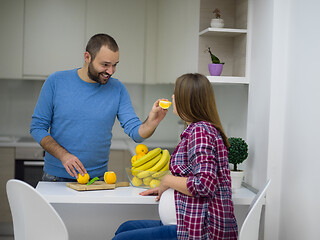 Image showing couple cooking food fruit lemon juice at kitchen